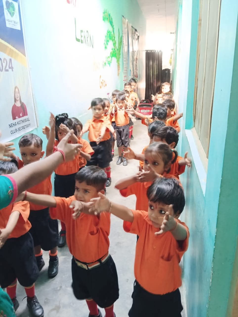 Vidhya Peeth school children raising hands forward for morning exercise